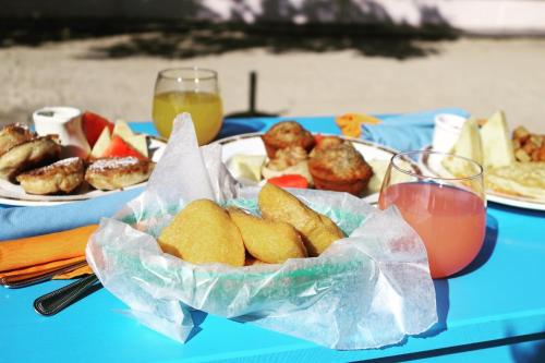
a table topped with plates of food and drinks at Mariposa Belize Beach Resort in Placencia

