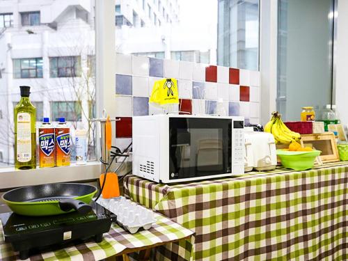 a microwave sitting on top of a table at 24 Guesthouse Seoul City Hall in Seoul