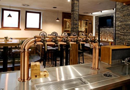 a bar with a row of chairs in a restaurant at Nábřežní terasy in Žďár nad Sázavou