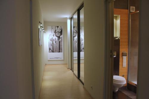 a hallway of a bathroom with a toilet and mirrors at Apartment with GARDEN in CITY CENTER in Krakow