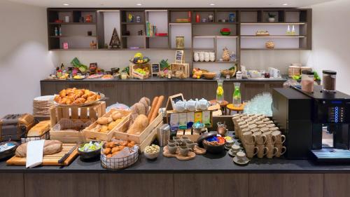 a bakery with a display of bread and pastries at Radisson Blu Hotel, Bruges in Bruges