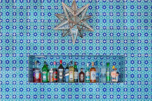 a row of alcohol bottles on a shelf in a wall at Villa Boheme Exclusive Luxury Suites in Positano