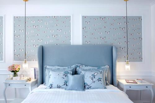 a bedroom with a blue bed with blue pillows at Thalassa Boutique Hotel - Adults Only in Lassi