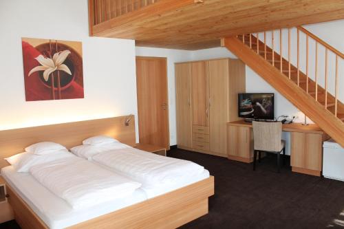 a bedroom with a bed and a staircase at Gasthof zum goldenen Löwen in Nauders