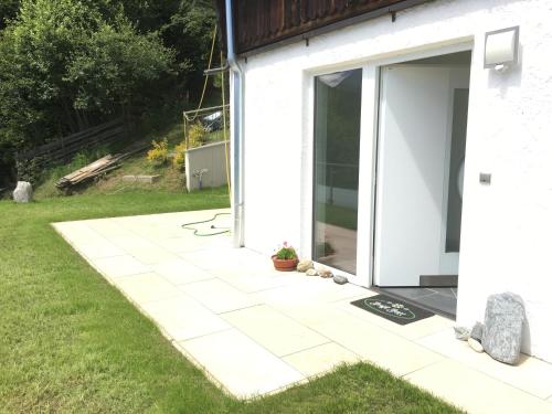 a patio with a door on the side of a house at Koflers Ferienwohnungen in Oberperfuss