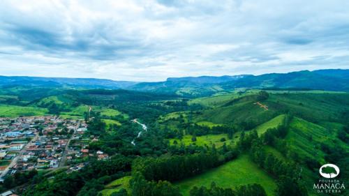 an aerial view of a city in the hills at POUSADA MANACÁ DA SERRA in Vargem Bonita