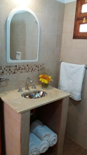 a bathroom with a sink and a mirror at La Cabañita de Tilcara in Tilcara