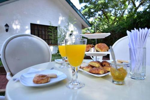 a table with two glasses of orange juice and pastries at Palm Valley in Nairobi