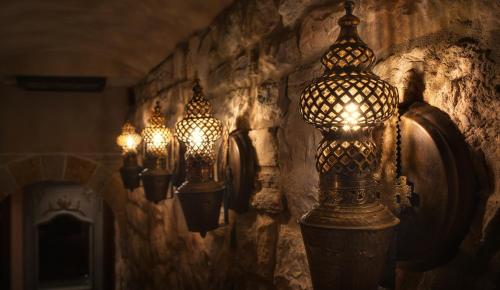 a group of lights hanging on a stone wall at KAMARES Historic Boutique Hotel & Spa in Ioannina
