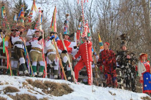 a group of people standing around in a parade in the snow at Edelsteinhotel Guniwirt in Krakaudorf
