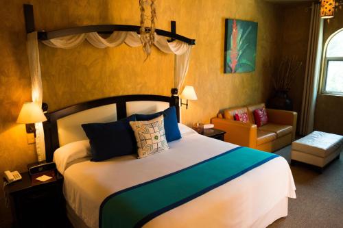 a bedroom with a bed and a living room at El Chante Spa Hotel in Jocotepec