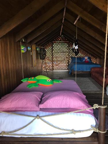 a bedroom with a large bed with pink sheets at Cabaña rodeada de naturaleza en San Carlos in Quesada