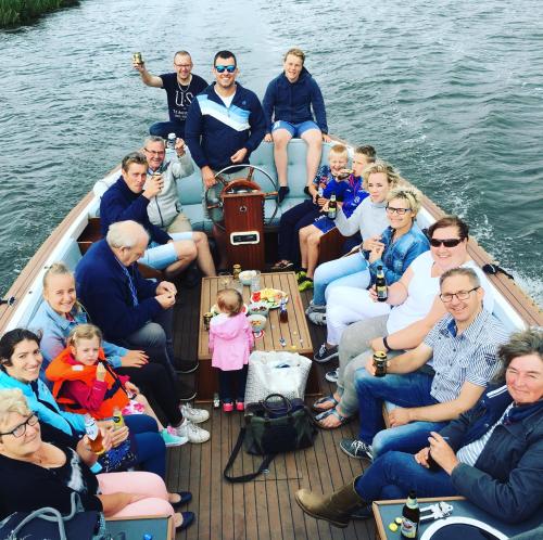 a group of people sitting on a boat on the water at Verblijf bij Bynt in Sneek