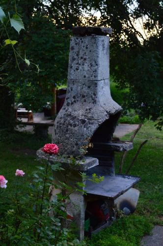 a stone oven with a flower on top of it at Na Okić - a private forest oasis in Sveti Martin pod Okićem
