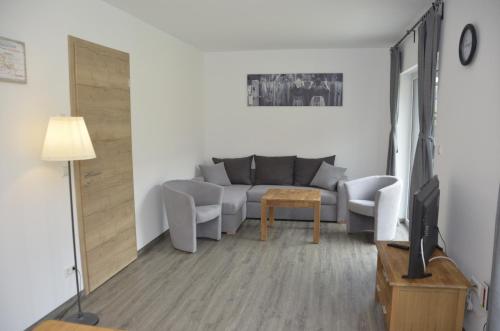 a living room with a couch and a table at Spreewaldpension Hahn in Alt Zauche