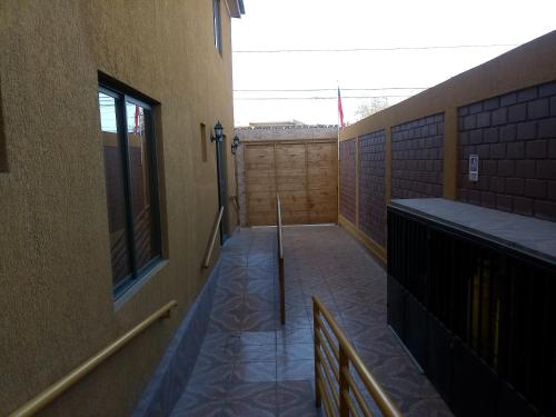 an empty hallway of a building with a fence at Casa Huespedes Angoba in Arica