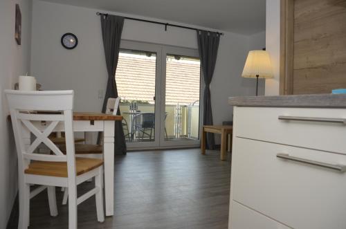 a kitchen with a table and a chair and a desk at Spreewaldpension Hahn in Alt Zauche
