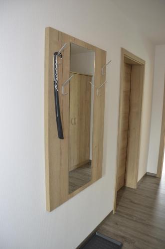 a mirror hanging on a wall in a room at Spreewaldpension Hahn in Alt Zauche