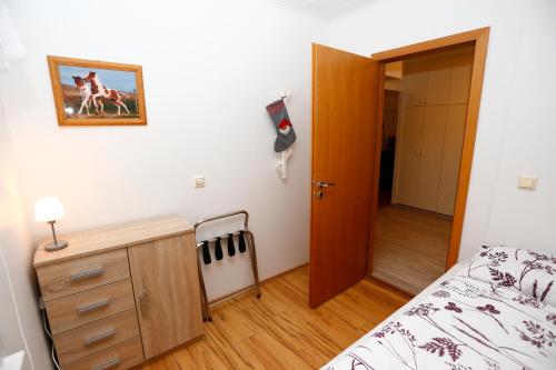 a bedroom with a bed and a dresser and a door at Hellnafell in Grundarfjordur