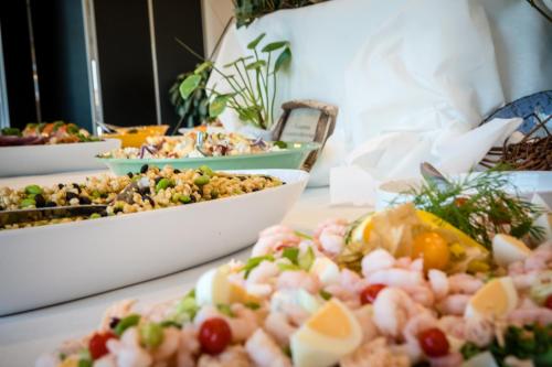 a table with many plates of food on it at Skærbæk Holiday Center in Skærbæk