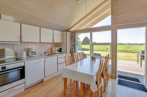 a kitchen with a table and a table and chairs at Skærbæk Holiday Center in Skærbæk