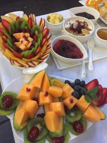 a table topped with plates of fruit and bowls of dips at Western Greenway B&B in Newport