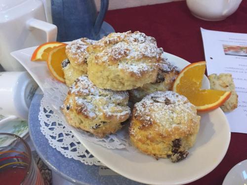 a plate of muffins with orange slices on it at Western Greenway B&B in Newport