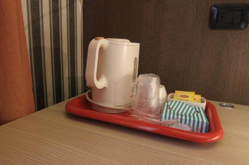 a coffee maker sitting on a tray on a counter at Hotel Metrò in Milan