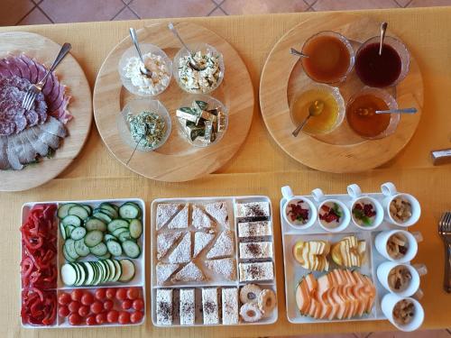 a table with plates of food and bowls of food at Tourist Farm Kranjc in Kobarid