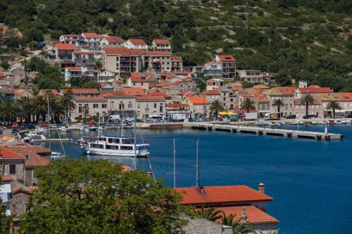 a town with a marina with boats in the water at LuceIssa (Beautiful Seaview Apartment) in Vis