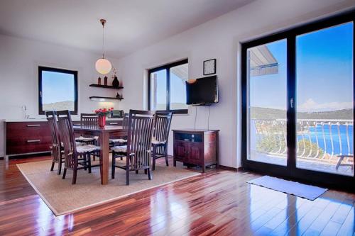 a living room with a dining room table and chairs at LuceIssa (Beautiful Seaview Apartment) in Vis