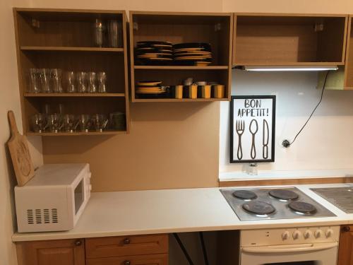a kitchen with a stove and a microwave at Pension Žacléřský Medvěd in Žacléř