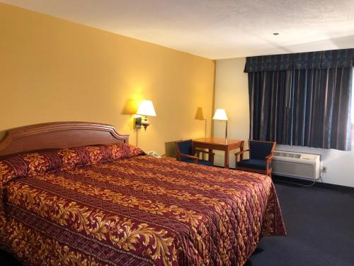 a hotel room with a bed and a desk at Luxury Inn in Norwalk