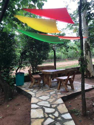 a picnic table with a colorful umbrella over it at Los Lapachos in Altos