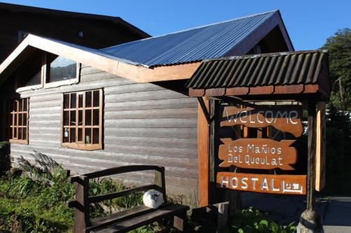 a building with a sign in front of it at Los Mañíos Del Queulat Puyuhuapi in Puerto Puyuhuapi