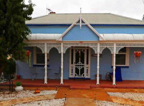 a blue house with a white front door at Ella's Place in Broken Hill