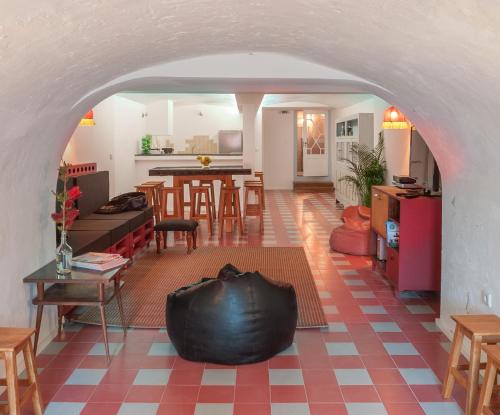 a living room with a large black object on the floor at Baga de Sal Wine Guesthouse in Aveiro