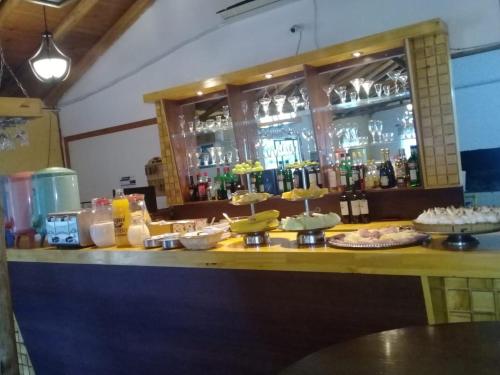 a bar with a counter with food and drinks at Complejo Cantonavi in Mina Clavero