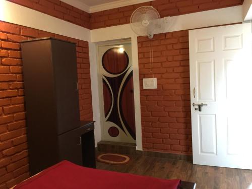 a room with a brick wall and a door at Marsim Holiday Resort in Vythiri