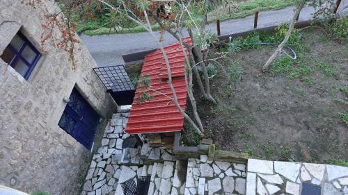 an overhead view of a red bench next to a building at The old olive mill house in Aegae
