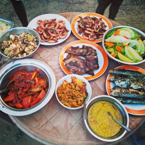a table with many bowls of different types of food at Bella Nilaveli Beach in Nilaveli