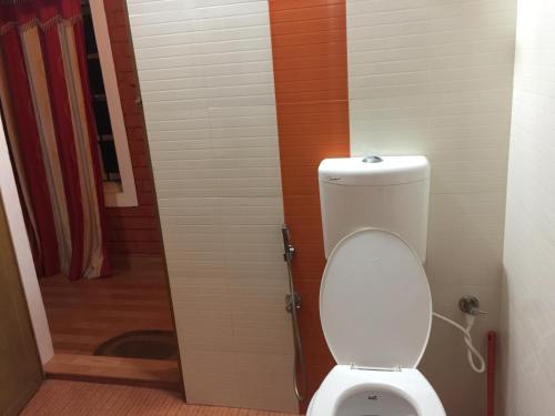 a bathroom with a toilet in a room at Marsim Holiday Resort in Vythiri