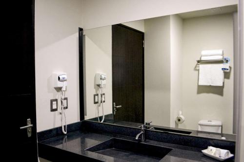 a bathroom with a sink and a large mirror at Comfort Inn Irapuato in Irapuato