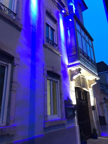 a building with blue lights on the side of it at Hôtel Saint Philibert in Tournus