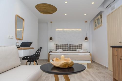 a living room with a couch and a table at Korali Hotel in Naxos Chora