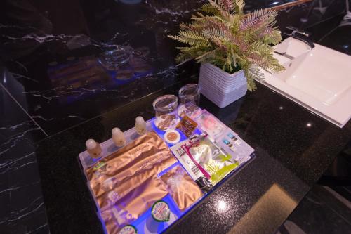 a table with a tray of food and glasses on it at J Moon Villa Motel in Taipei