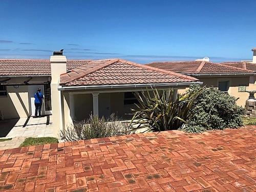 a person standing in the doorway of a house at 123 hbc in Hermanus