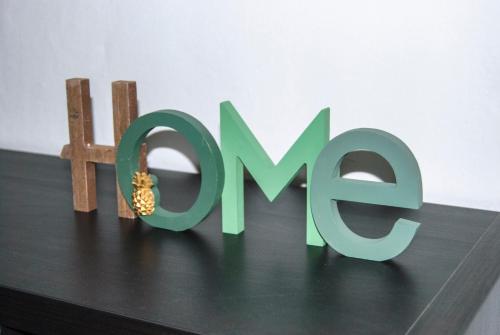 a green sign that says open on top of a table at AT HOME IN CREMONA in Cremona