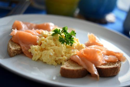 a plate of food with salmon and eggs on toast at Avron House in Torquay