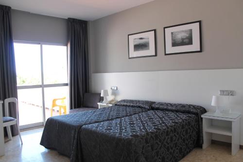 Postel nebo postele na pokoji v ubytování Hotel Marola